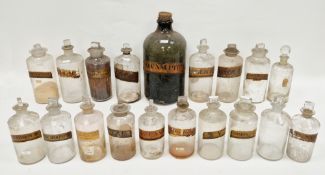 Collection of late 19th and early 20th century labelled glass apothecary jars and assorted stoppers,