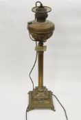 Victorian brass Corinthian column oil lamp, later converted to electricity, the circular well on a