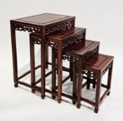 Chinese hardwood nest of four tables, the rectangular tops with pierced dragon carved friezes, on