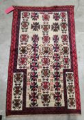 Cream ground baluchi prayer rug with central geometric field, single geometric border, 134cm x 82cm