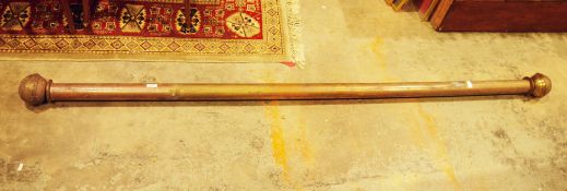 Late 19th / early 20th century gilt metal cylindrical curtain rail with globular end finials,