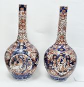 Large pair of Japanese Meiji period bottle vases, decorated in the imari palette with a phoenix