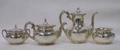 Sterling silver four-piece tea service, comprising teapot, hot water jug, covered sugar bowl and