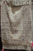 20th century cream ground silk rug, probably Anatolian, with a central foliate medallion, within