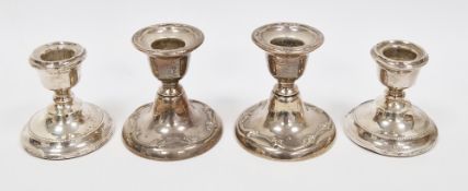 Two pairs of weighted silver dwarf desk candlesticks, the first pair Edward VII, Birmingham 1908,