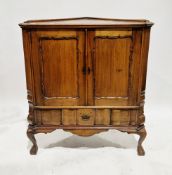Early 20th century walnut floor standing corner unit having two panel doors with shaped moulded
