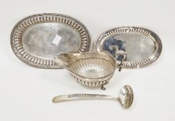 Sterling silver sauceboat on stand, both with gadrooned rims and half lobed body, the boat with leaf