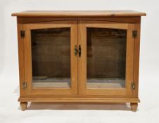 Contemporary pine and glazed side cabinet, the rectangular top over a pair of glazed doors with