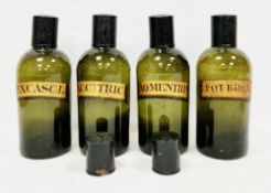 Four 19th century labelled green-glass 'shop round' apothecary bottles and six black painted tin
