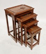 Chinese hardwood nest of four tables, each table carved with a relief scene of figures in a