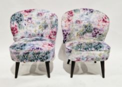 Pair of Clarke & Clarke contemporary easy chairs upholstered in a floral pink and green fabric, on