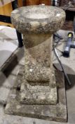 Reconstituted stone birdbath, simple circular dish on waisted column, square plinth base 70cm.