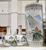 Chinese umbrella stand of cylindrical form decorated with continuous landscape, 46cm high and a pair