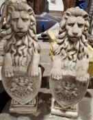 A pair of reconstituted stone heraldic lions with front paws resting on armorial shields ( 2) 75 cm