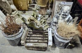 A large cast metal birdbath/fountain bowl in the form of a clam shell with two seated putti, a