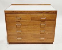 Mid-century Remploy teak military chest, the rectangular top with short back upstand and formica