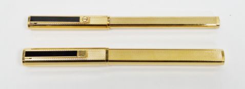 Dunhill fountain pen and matching ball point pen, gold coloured cases with engine turned decoration,