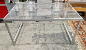 Mid-century steel-framed dining table with clear perspex top, on square legs united by side