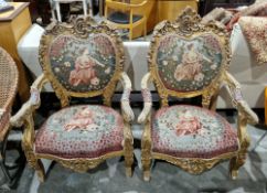 Pair of giltwood throne type chairs in the rococo manner, with foliate scroll carving, the back