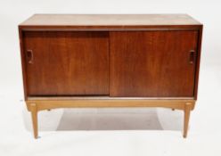Mid-century Danish-style teak sideboard with two sliding panel doors, having moulded handles, on a