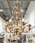 Gilt metal six-branch chandelier in the rococo manner, with foliate leaf decoration and prismatic