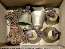 Collection of six late 19th or early 20th century brass bells with leather loop handles, largest