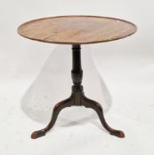 George III mahogany table, the circular tilt-top with moulded edge, on a turned baluster pedestal