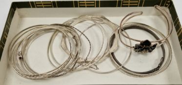 Collection of eighteen mainly silver bangles including an octagonal engraved hinged bangle with