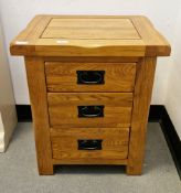 Modern Oak Furnitureland bedside cabinet, the square top over three drawers with metal drop loop