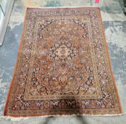 Eastern style reddish brown ground rug, decorated with a central medallion and flowers within a