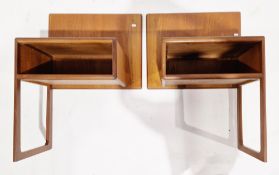 Pair of mid-century teak bedside units, wall or headboard mounted, each with a back panel holding