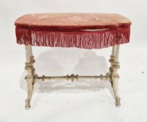 19th century table, the fabric covered shaped top with fringe, on a grey and gilt painted base, with