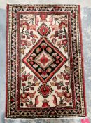 Small Iranian cream and red ground wool rug, decorated with a central medallion surrounded by