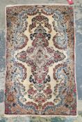 Floral pattern rug, decorated in a blue and pink palette on a cream ground, 147cm x 89cm