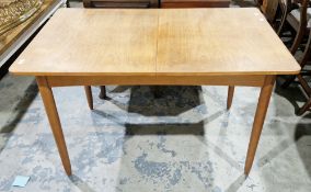 Mid century Austinsuite teak dining room table, the rectangular top extending with a pull-up leaf,