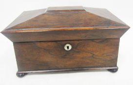 Regency rosewood tea caddy of sarcophagus form, the hinged lid opening to a space for a bowl and two