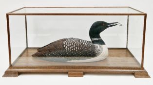 Michael Lythgoe (b.1950), hand-carved and painted model of a Great Northern Diver bird holding a