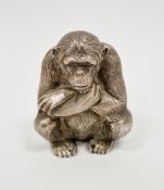 Asprey & Garrard silver desk weight, cast in the form of a seated monkey or chimpanzee, London 2000,