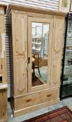 Victorian stripped pine wardrobe, the moulded cornice over a single mirrored door, opening to a