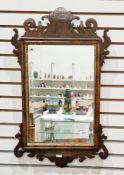 Mahogany and parcel-gilt wall mirror in the George III manner, with fretwork carved frame, 73cm x