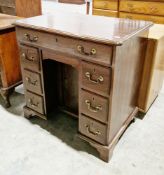 Mahogany kneehole desk in the George III manner, the rectangular top with thumbmoulded edge, over an