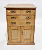 Early 20th century pine cupboard, the rectangular top over three long drawers, each with brass