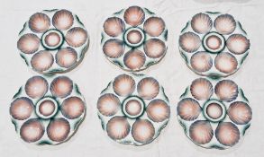 Set of six Sarreguemines majolica oyster dishes, each circular with six scallopshell plates in blue,