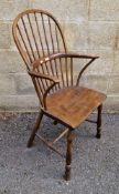 19th century elm and ash hoop and comb back elbow chair with saddle seat, on turned legs united by