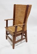Oak framed Orkney chair with woven rush back and drop-in seat, having carved scrolling arms, on
