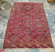 Tekke Turkmen type red ground wool rug, decorated with rows of guls within a border, 219cm x 136cm