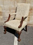 Open library armchair in the George III manner, having an upholstered square back, arm rest and