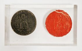 Bronze seal matrix, circular, with loop to reverse, of Ecclesiastical design depicting seated