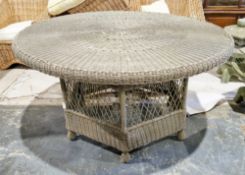 Large grey wicker garden dining table of circular form on hexagonal base, 143cm diameter x 77cm high