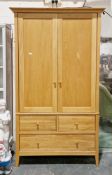 Willis & Gambier contemporary pale oak wardrobe, having two panel doors opening to a hanging